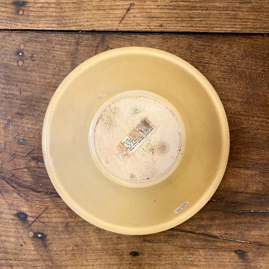 Underside of the Provençal cicada serving bowl with a label on the base