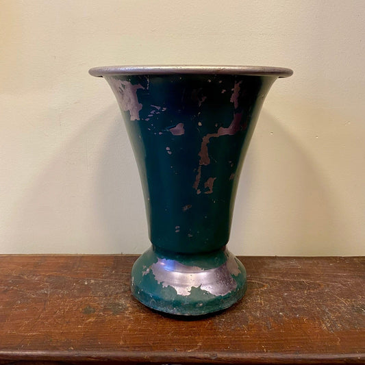 The green vase from another side, with a silver-coloured rim and paint worn away around the base
