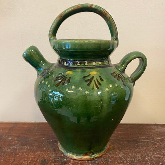 Pitcher from the front with brown fan motifs and rows of dots around the shoulder