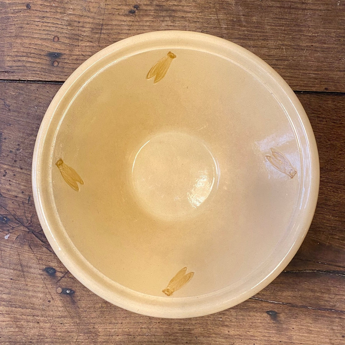 Large vintage French Provençal yellow serving bowl with four cicada motifs on the inside