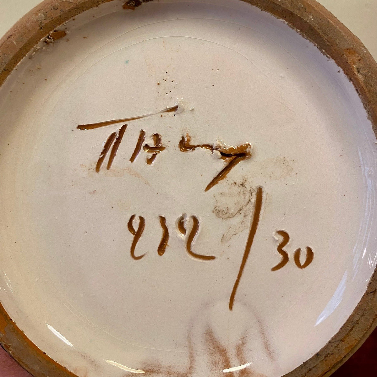 Underside of the vase with a handwritten mark