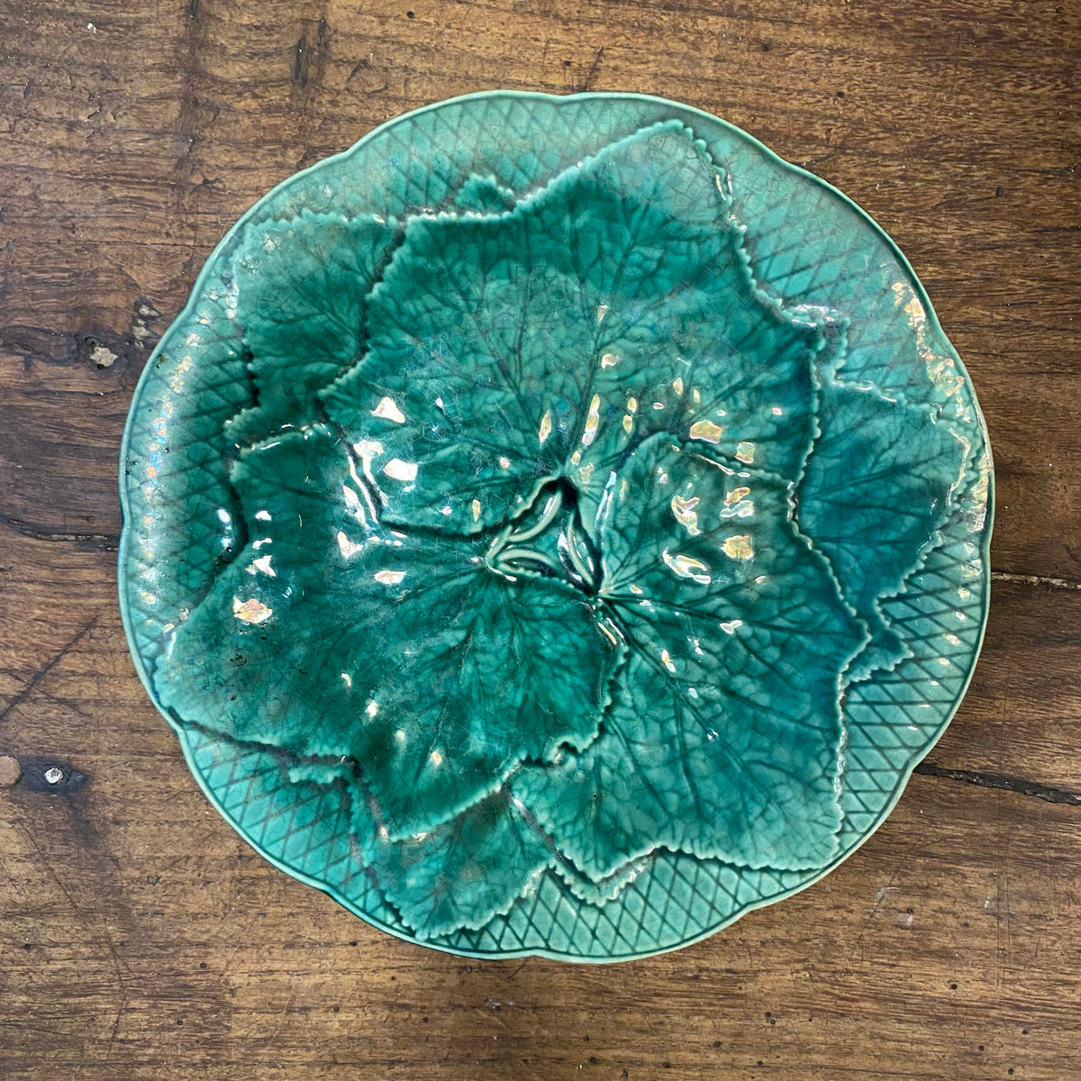 A third plate in a medium green with the leaf design and lattice border