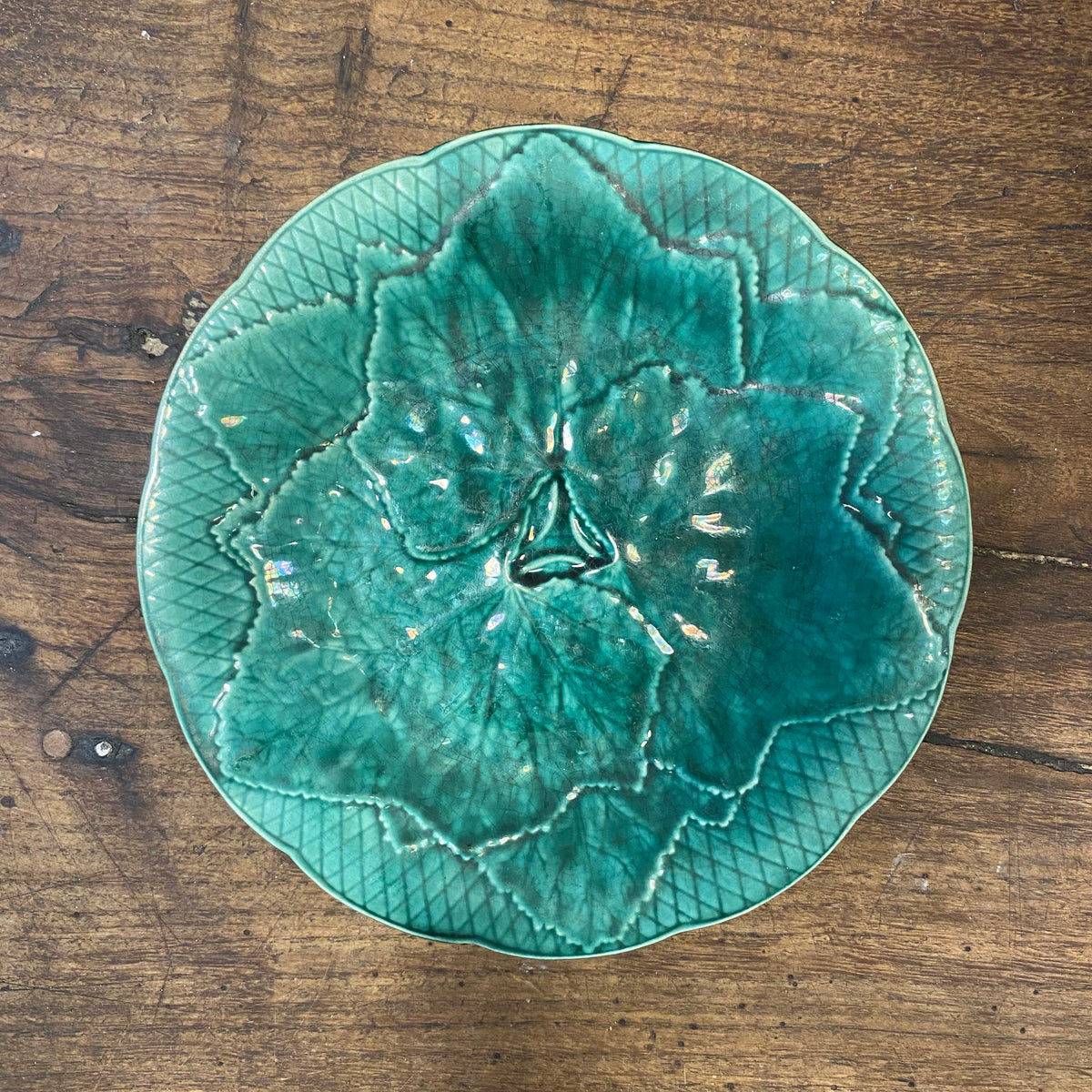 The fourth plate from above, with the leaf design, lattice border and an iridescent sheen