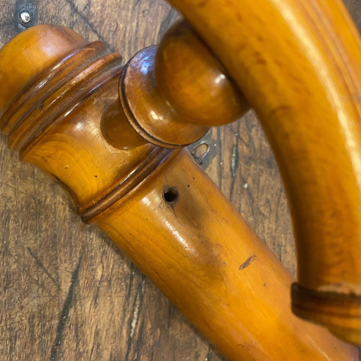 Close-up of the ringed turned detail and a small hole in the rail of a vintage French wall hook