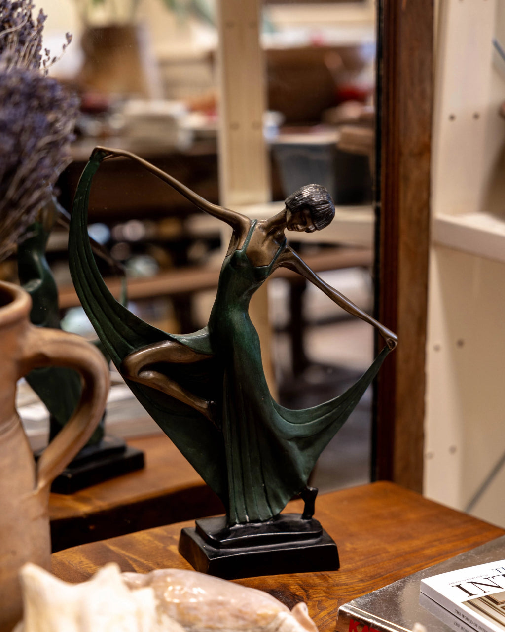 statue of a woman in a green dress.