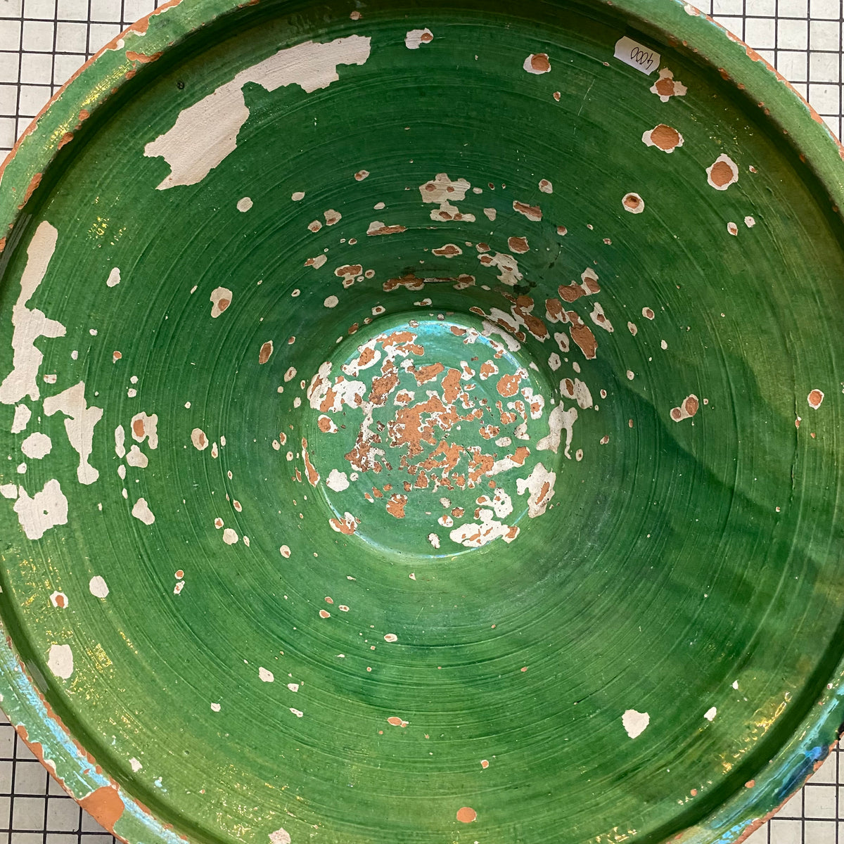 Close-up of the green-glazed interior of the tian bowl with glaze loss