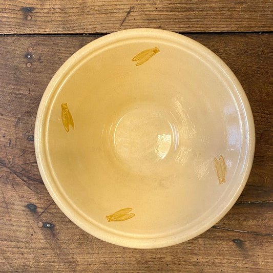 Vintage French Provençal yellow serving bowl with four cicada motifs on the inside