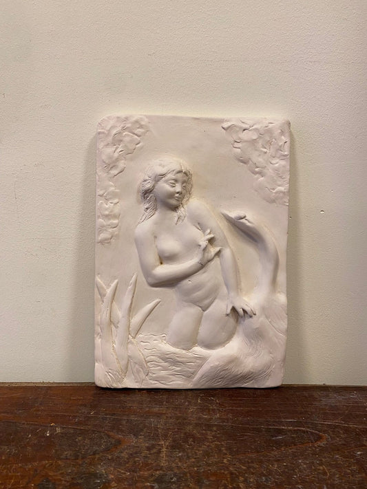 Vintage plaster wall relief of a woman standing among reeds with a swan beside her, front view