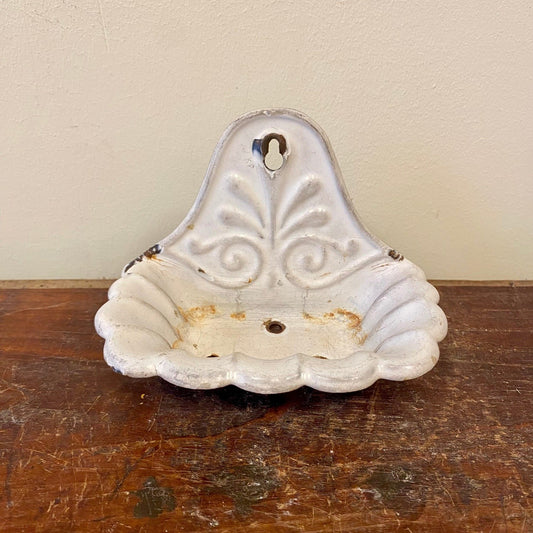 White enamel wall-mounted soap dish shaped as a scalloped shell, front view