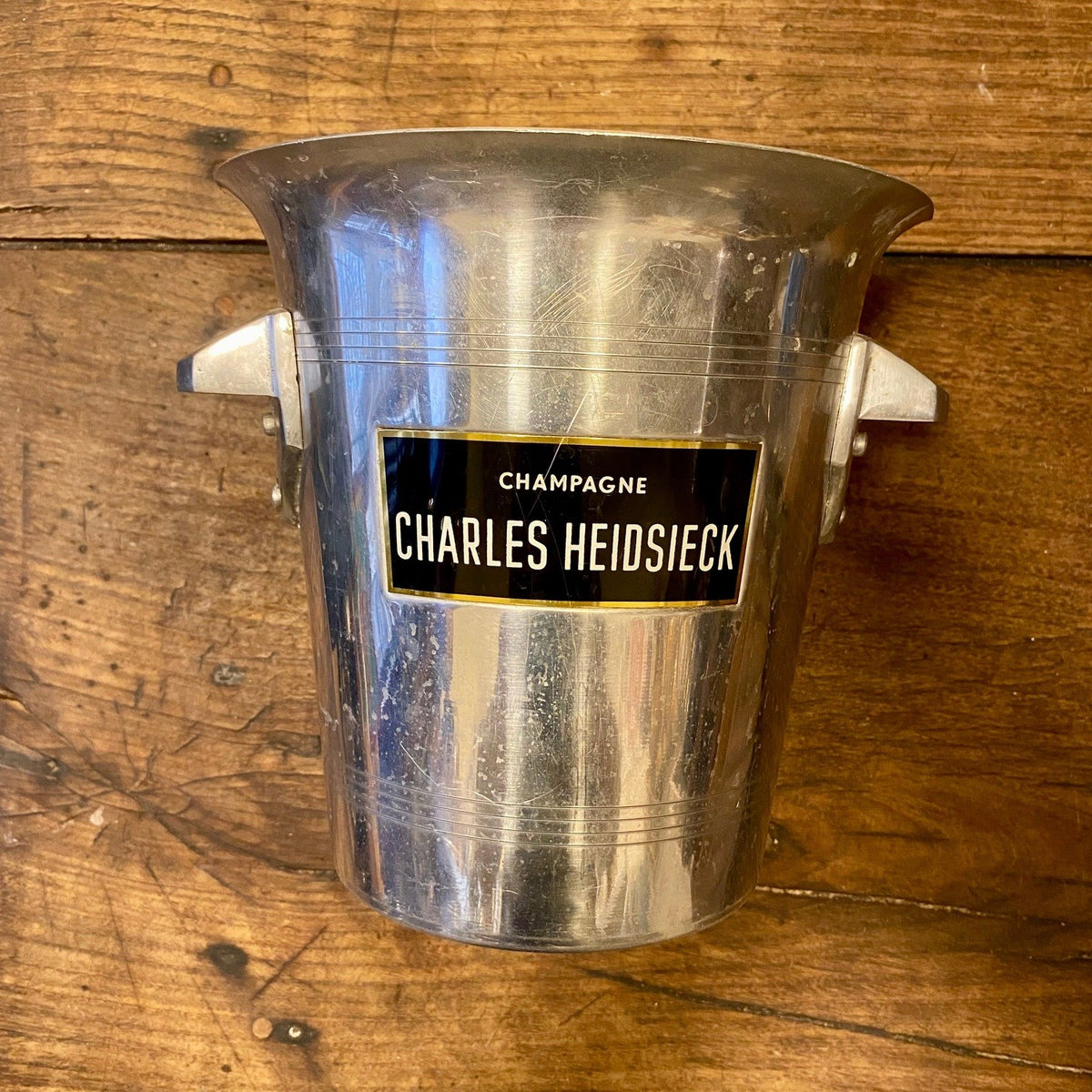 Vintage French Charles Heidsieck aluminium champagne bucket with angular side handles and a black and gold label