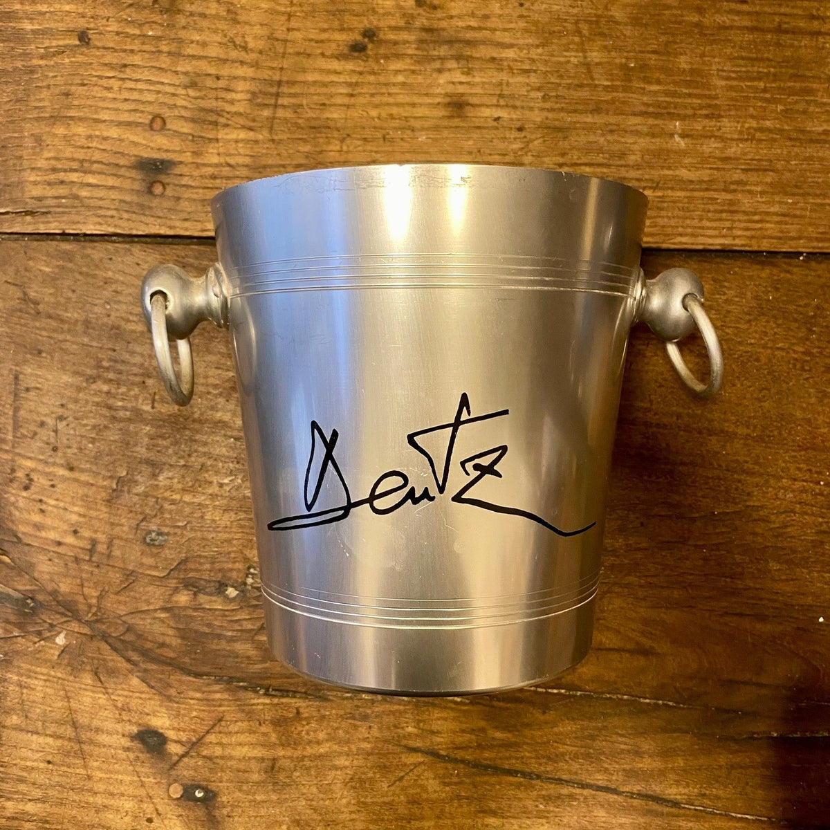 Vintage French Deutz aluminium champagne bucket with twin ring handles and the black Deutz signature on the front