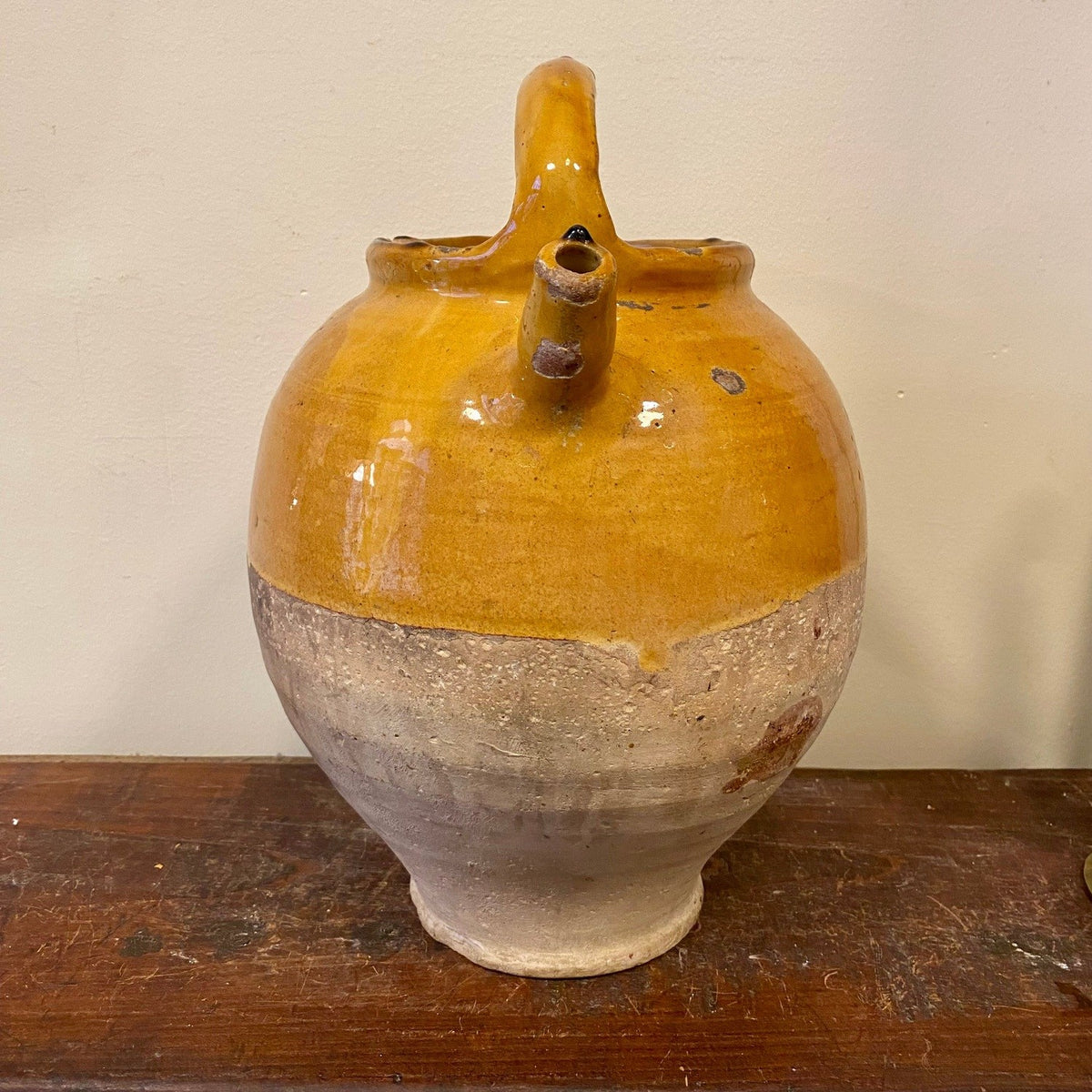 Jug seen from the spout side with the open spout and arched handle