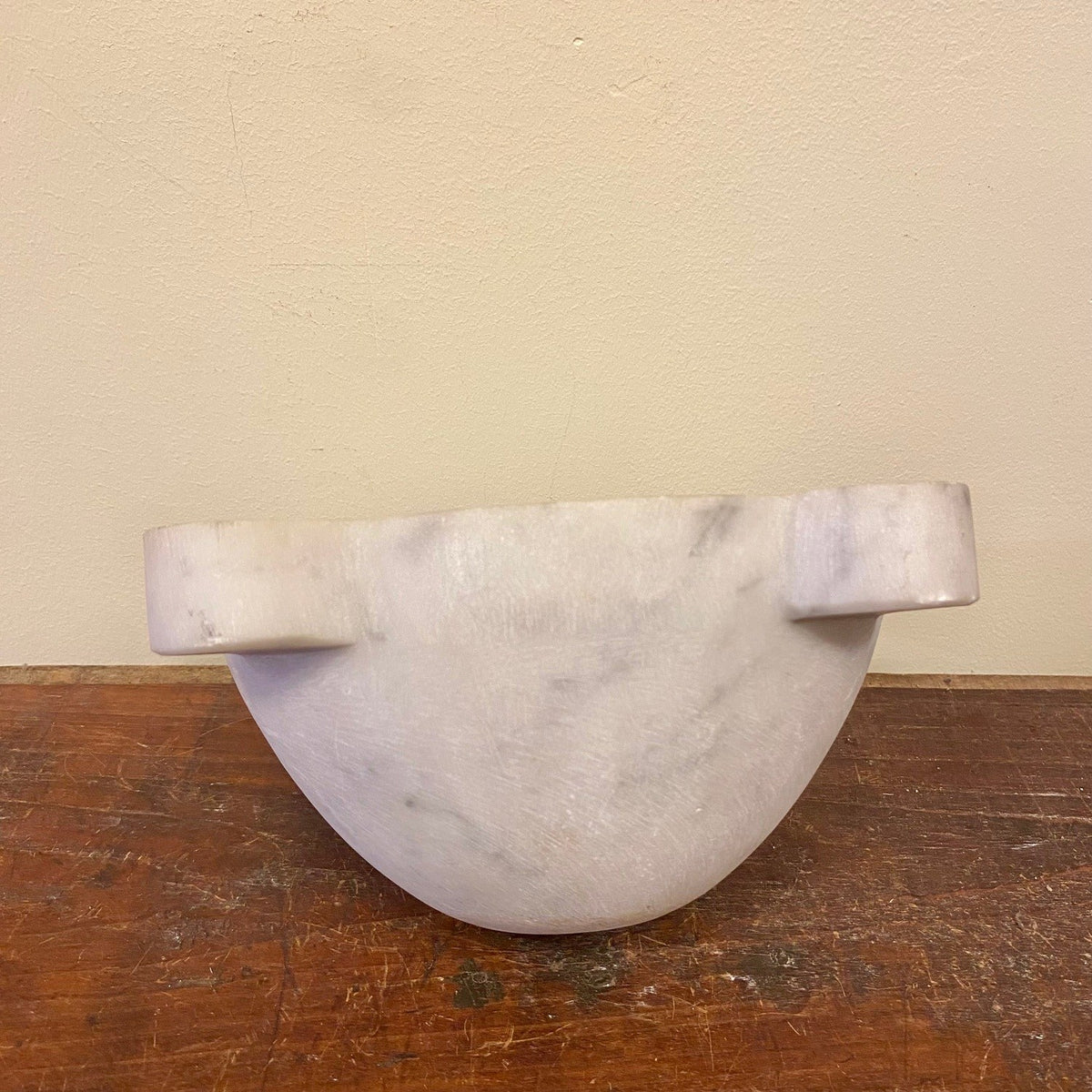 Marble mortar from the side, showing the bowl and two lugs