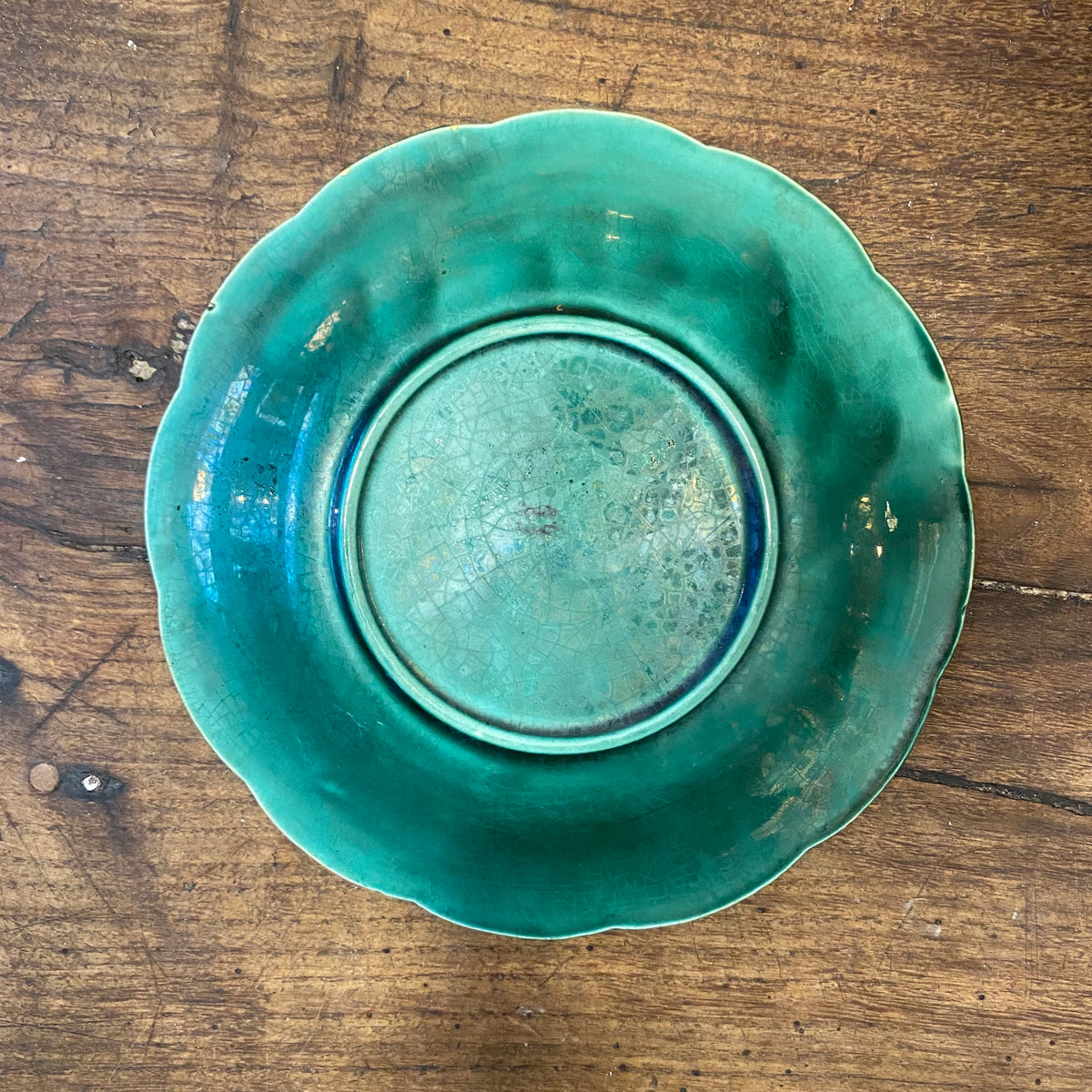 Back of the third plate, with crazed glaze and a faint mark on the foot