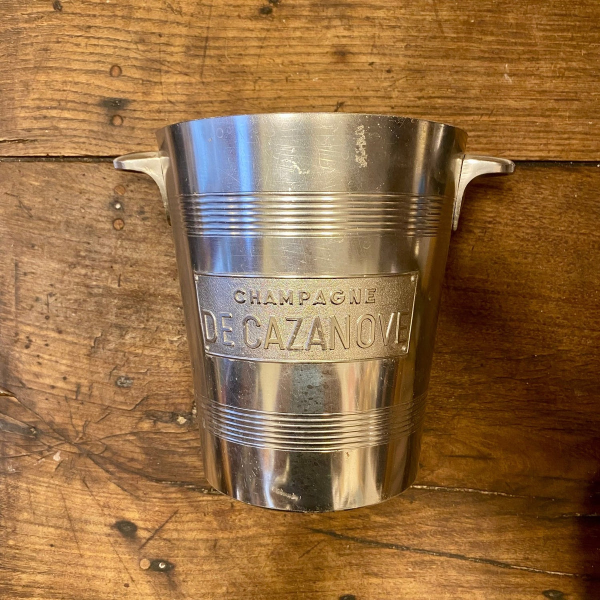 Vintage French De Cazanove aluminium champagne bucket with angular side handles, ribbed bands and a raised metal label