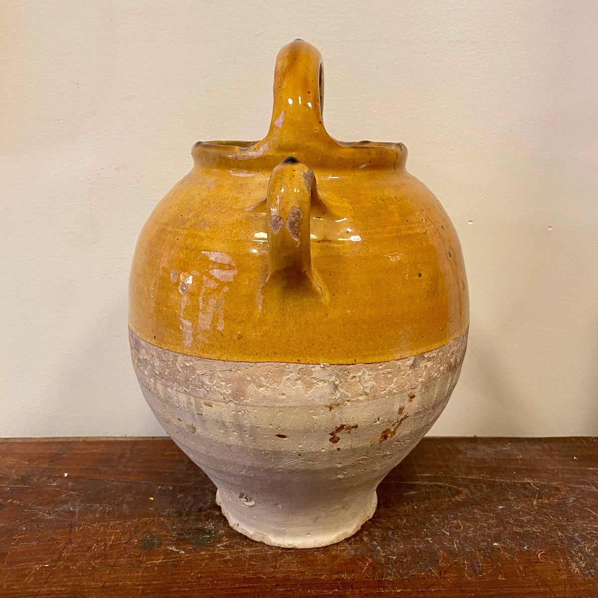 Jug side view showing the side handle and the line where the glaze stops