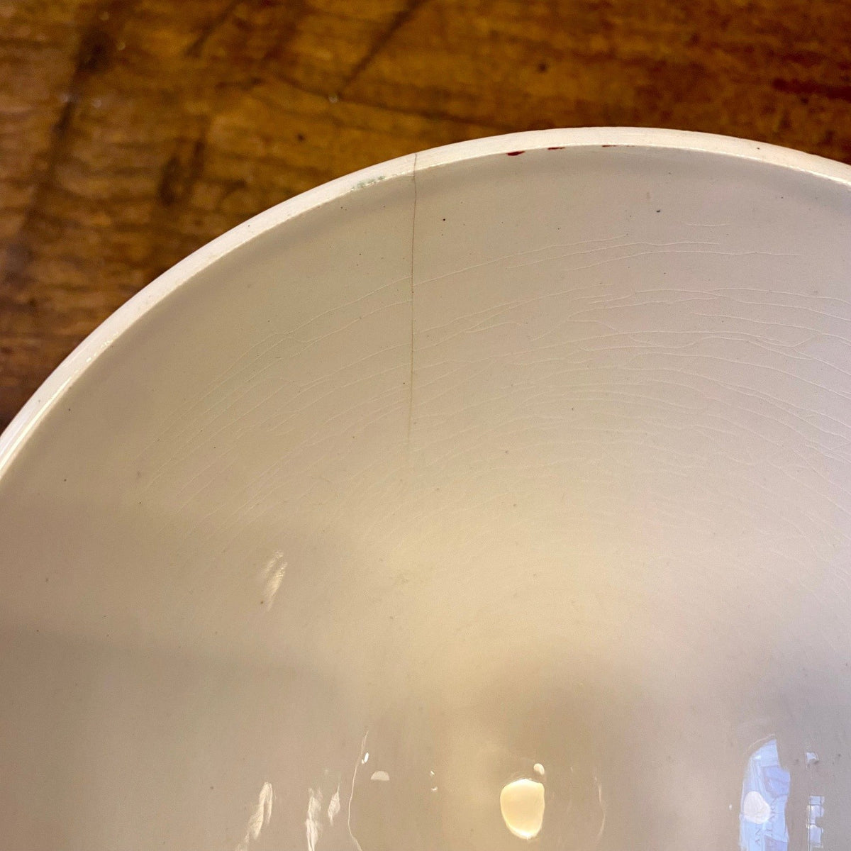 Close-up of the hairline crack at the inside rim of a vintage French café au lait bowl