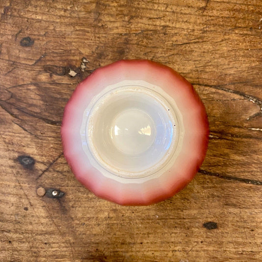 Underside and foot of a vintage French red café au lait bowl
