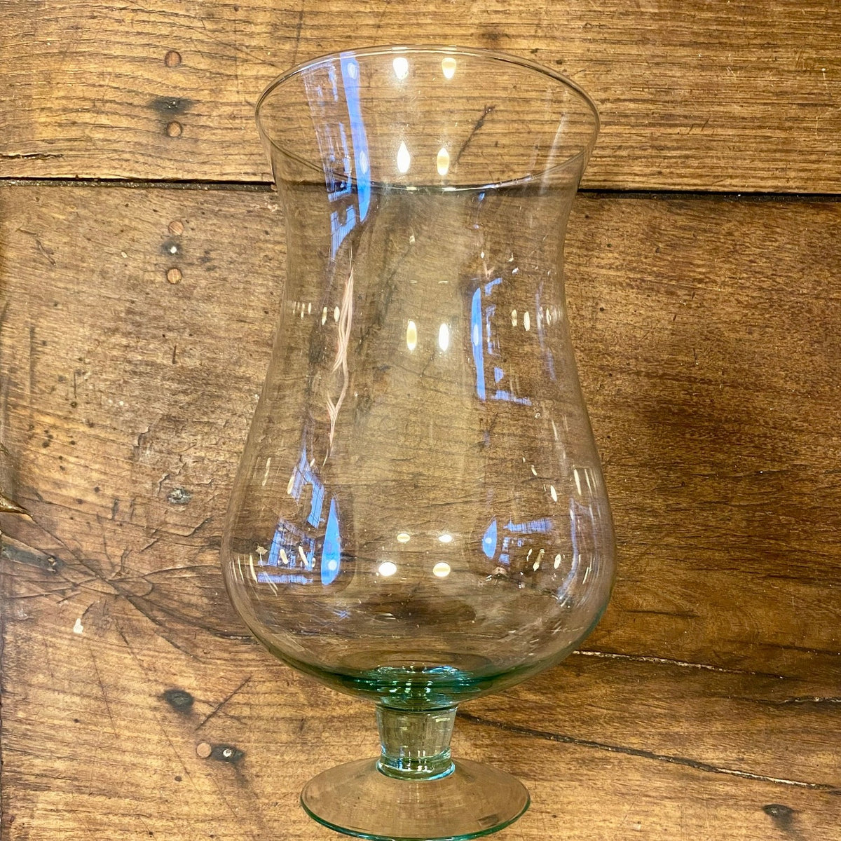 Vintage French footed glass vase with a curved body and flared rim