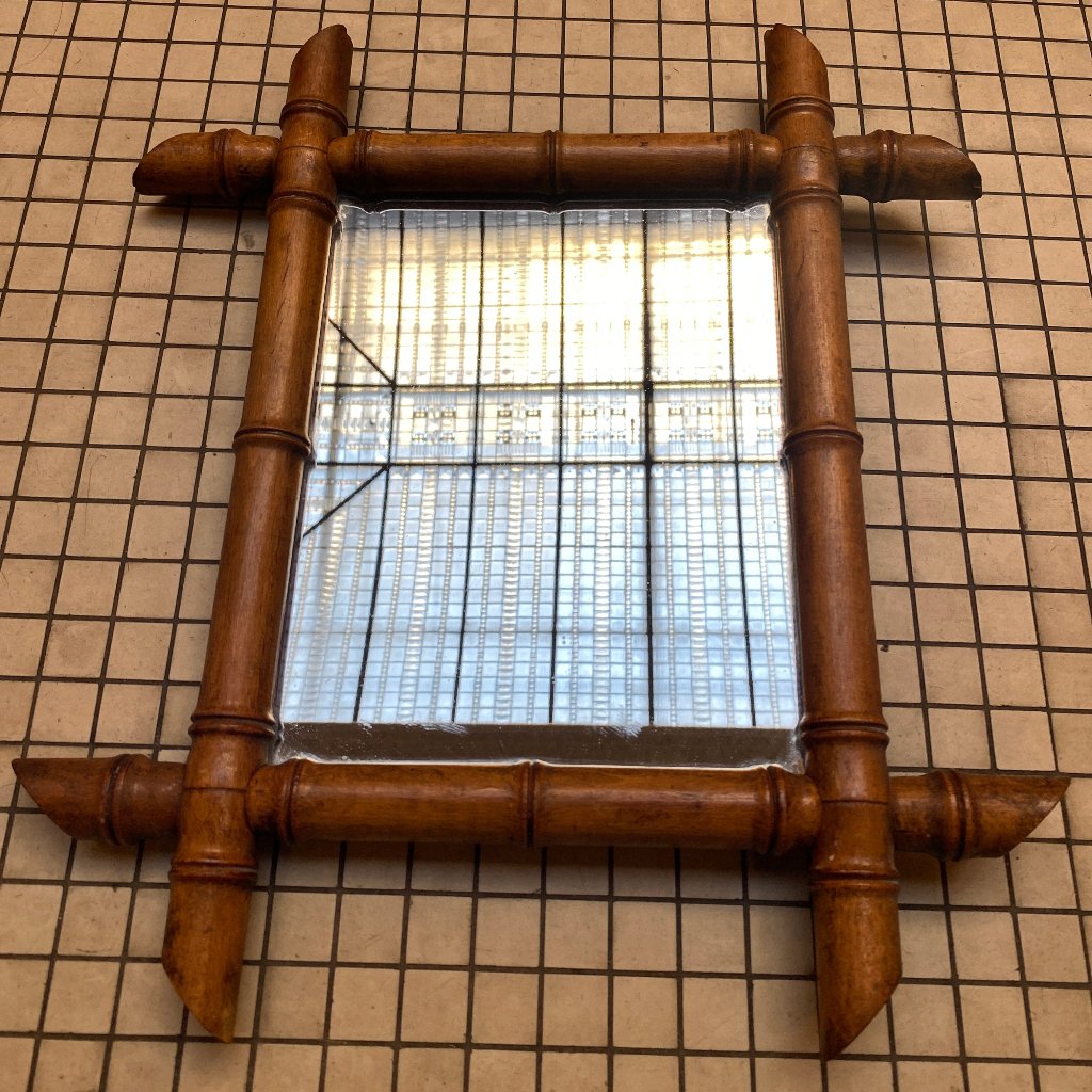 A mirror with a bamboo frame.