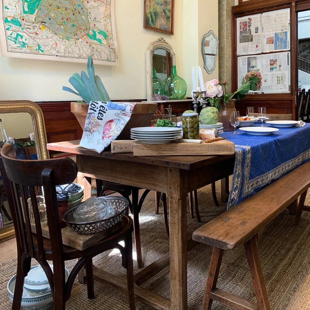 image showing an old farm table with interior details like cutting boards and kitchen towels. 